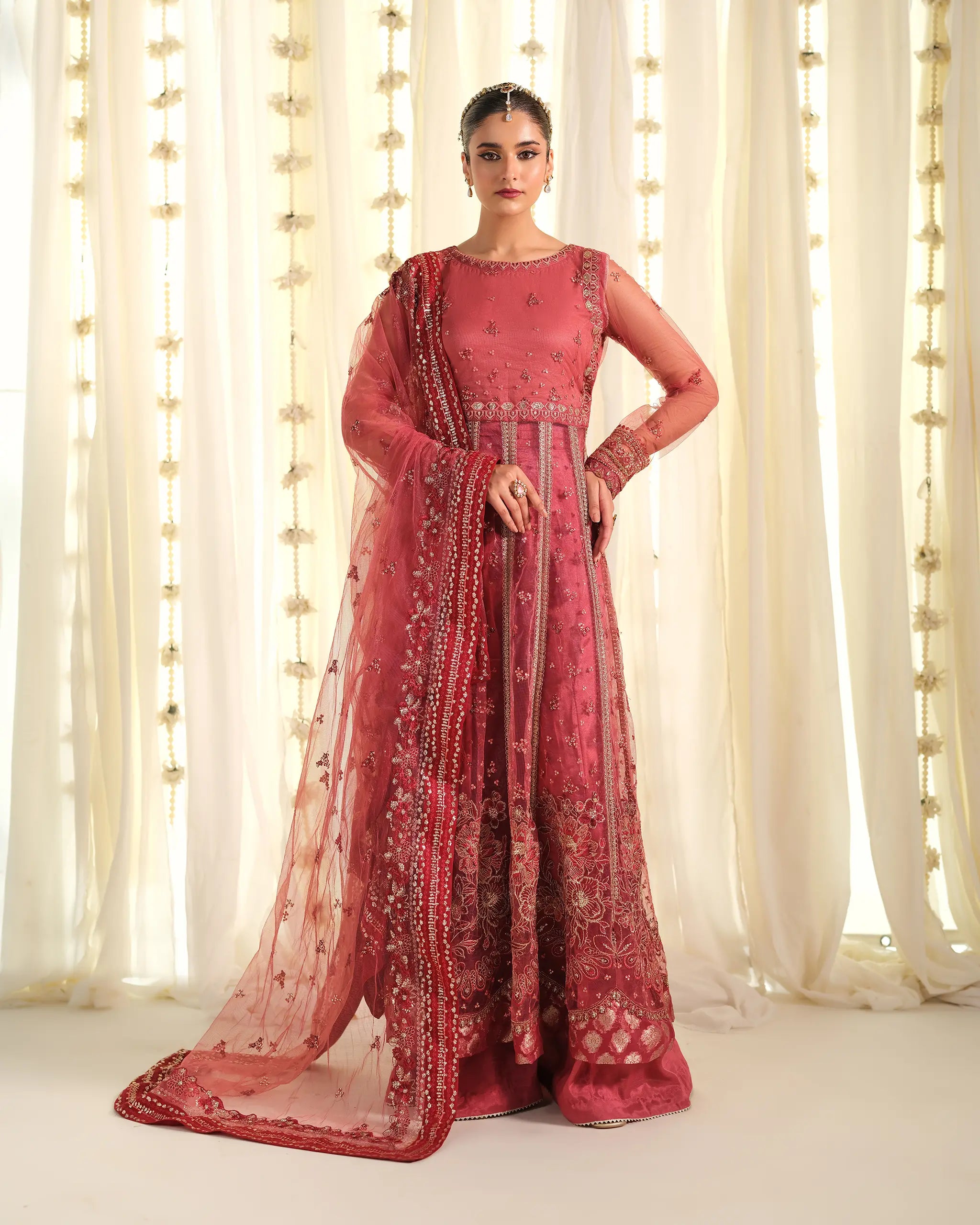 Full-length view of a model in the dusty pink, floor-length 'Mohabbat﻿' outfit with a long, sheer dupatta﻿ featuring dense floral embroidery.