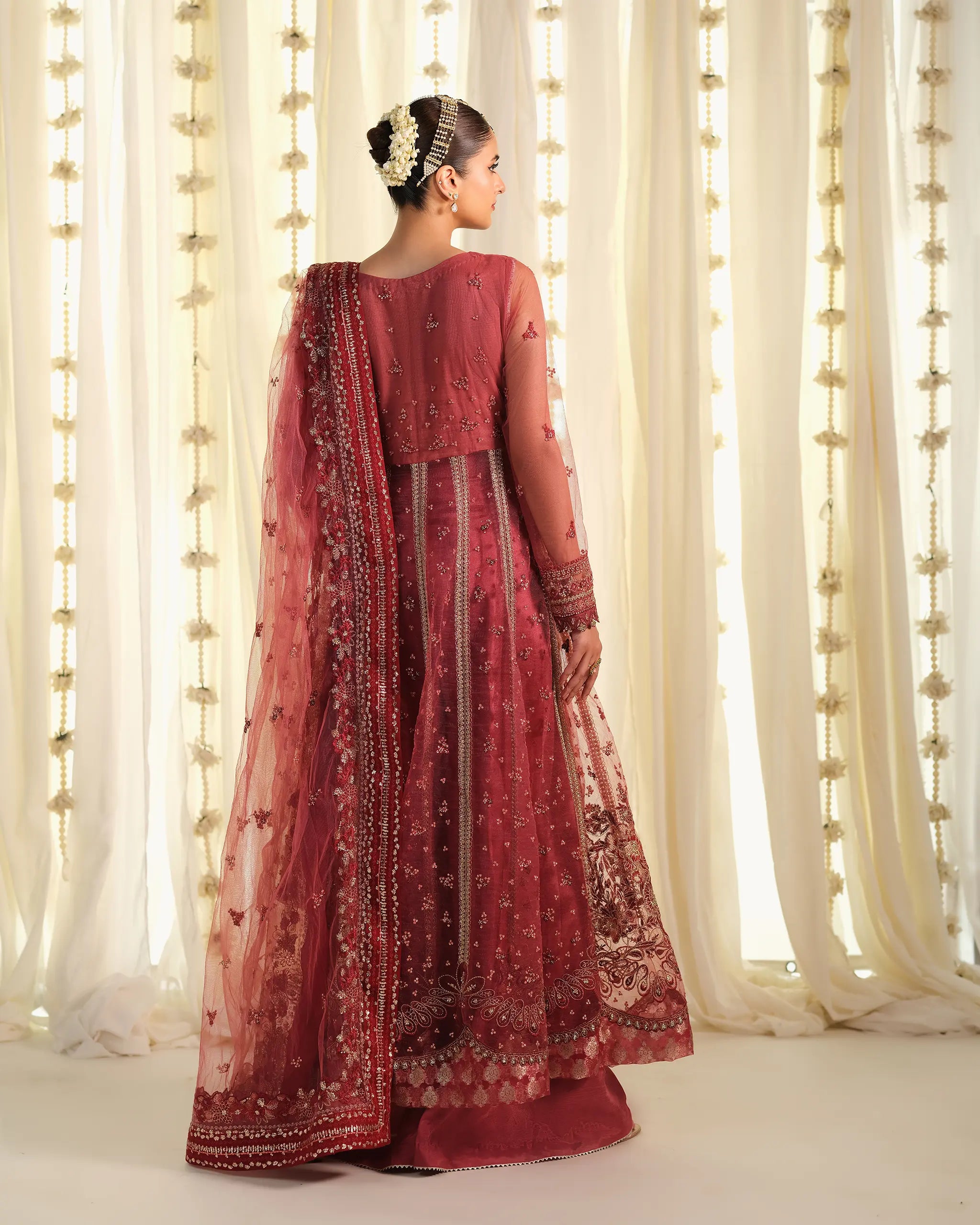 Back view of the Pehla Khat - Mohabbat﻿ outfit, displaying the sheer embroidered dupatta﻿ and a classic floral hair bun accessory.