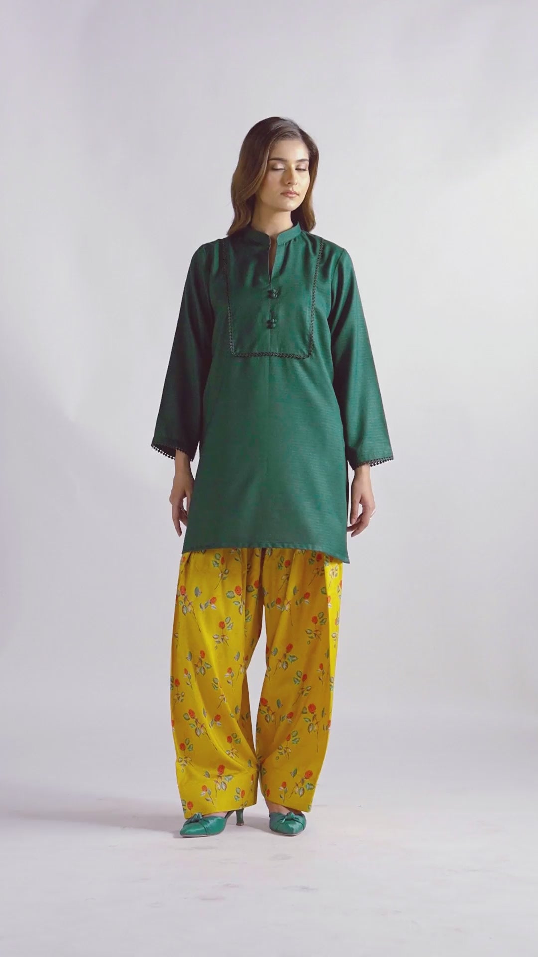 Sinoor's 'Nora' pret suit from the Winter Basic Collection. Features a dark green kurta paired with a vibrant yellow floral shalwar. Ready-to-wear for women.