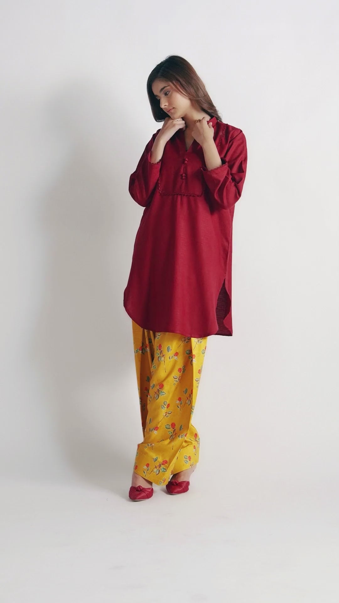 Sinoor's 'Nora' pret suit from the Winter Basic Collection, pairing a red kurta with a yellow floral shalwar. Stylish ready-to-wear for women.