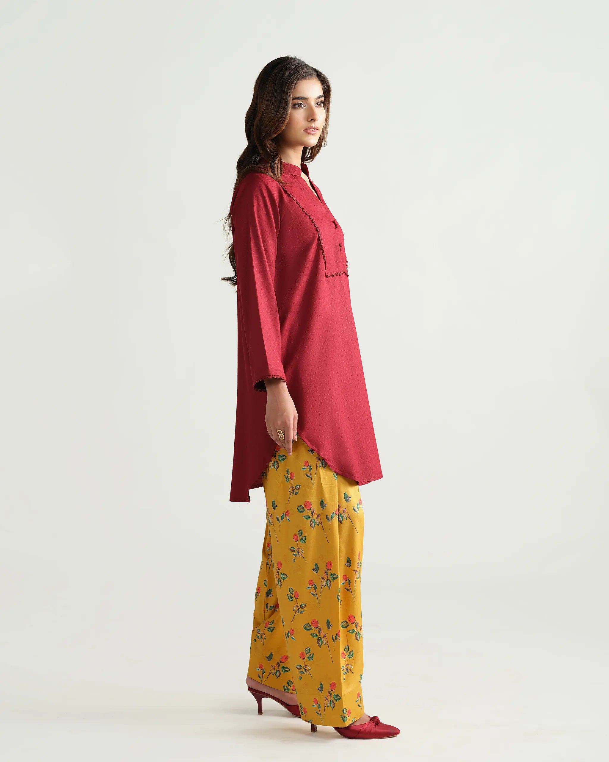 Sinoor's 'Nora' pret suit from the Winter Basic Collection, pairing a red kurta with a yellow floral shalwar. Stylish ready-to-wear for women.